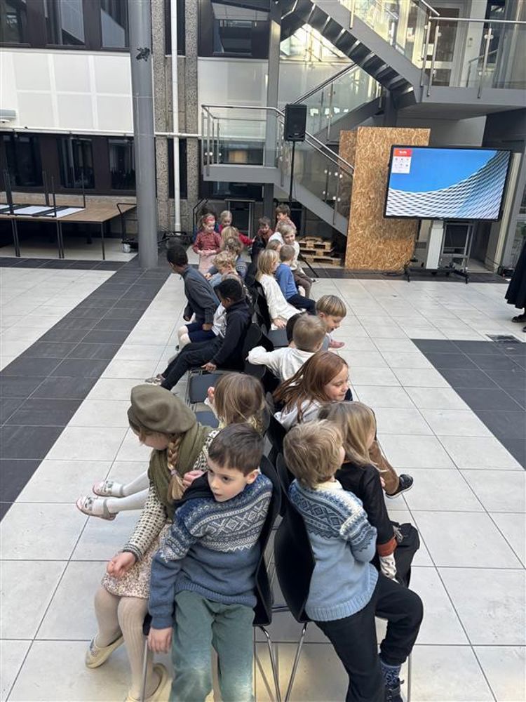 en gruppe mennesker som sitter på gulvet