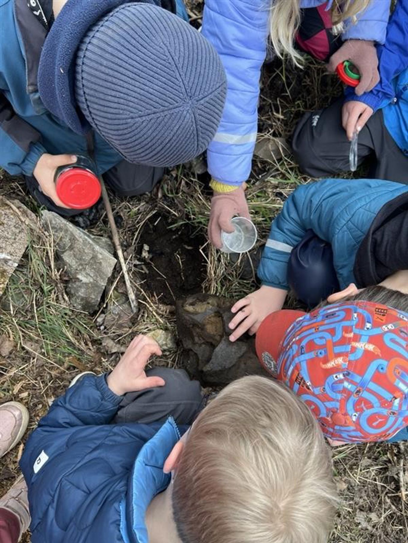 en gruppe mennesker som sitter på bakken en gruppe mennesker som sitter på bakken